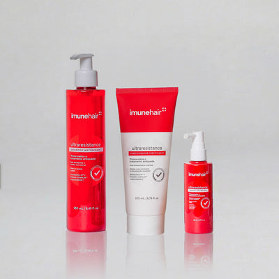 Embalagem vermelha do shampoo, condicionador e tônico, com os nomes UltraResistance Shampoo Antiqueda de 250ml, UltraResistance Condicionador Fortificante de 200ml e UltraResistance Tônico Antiqueda de 80ml.