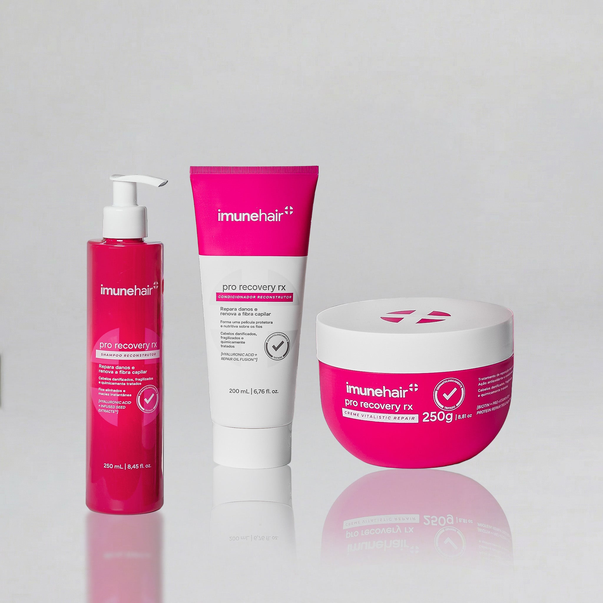 Produtos rosa e branco que compõe a linha reconstrutora Pro Recovery da Imunehair. São 3 produtos ao todo: shampoo de 250ml, creme de 250g e condicionador de 200ml.