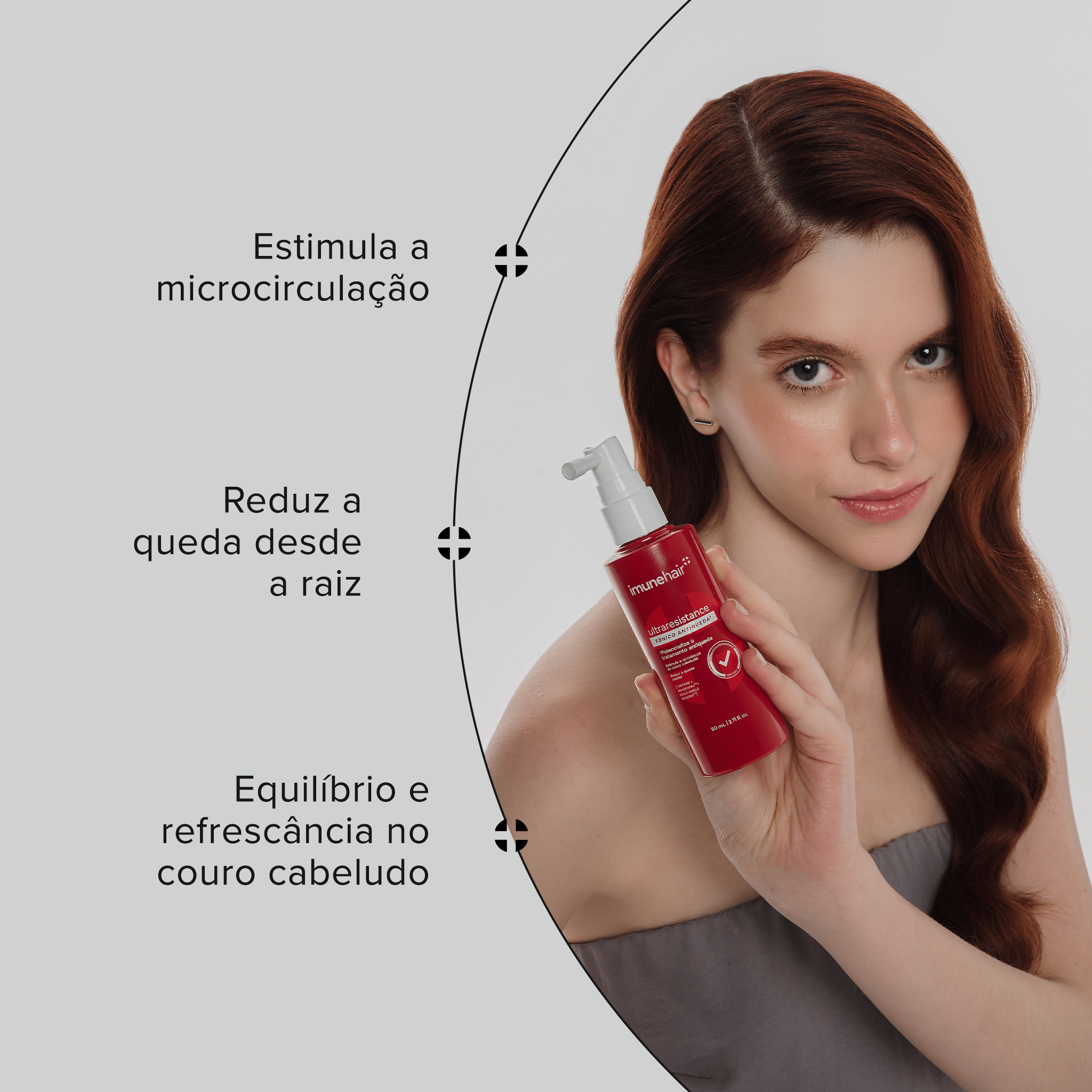 Mulher ruiva segurando o tônico antiqueda que estimula a microcirculação, reduz a queda, fornece equilíbrio e refresca o couro cabeludo. 